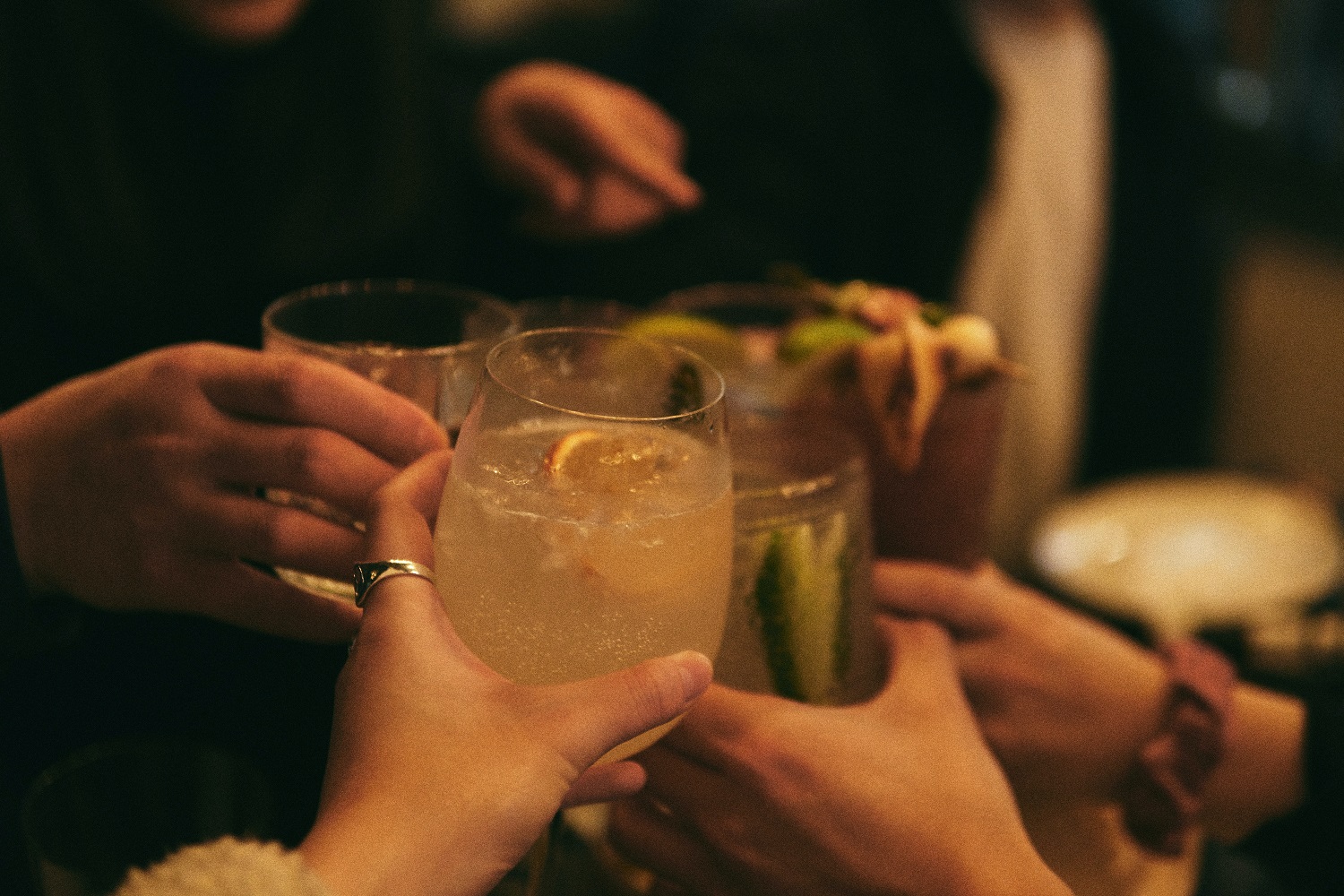 People giving a cheers with their drinks